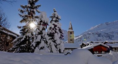 Snowy scene in Val d'Isere with church in the background 