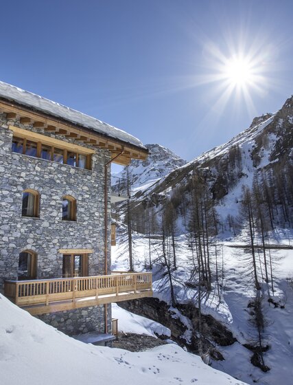 Exterior of snowy VIP SKI Bellevarde chalets in Val d'Isere on sunny day
