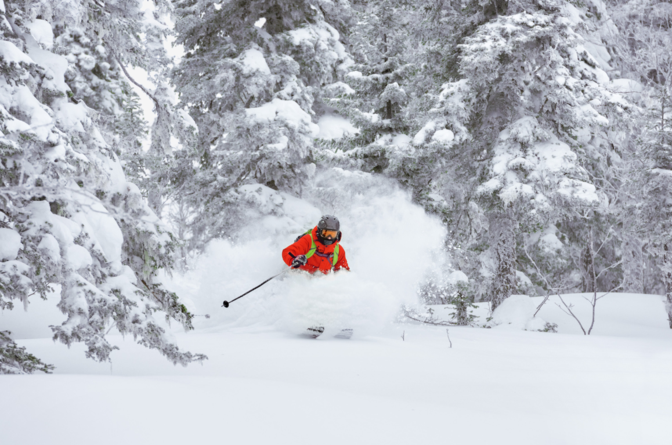 Skier skiing off-piste in deep powder