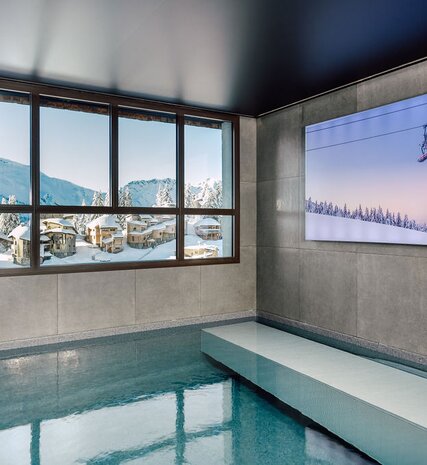 Indoor swimming pool with views of snowy Avoriaz in VIP SKI luxury chalet 