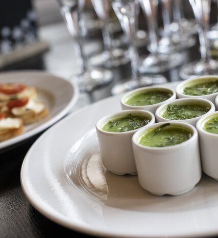 Two types of canapés laid out in front of some champagne glasses in a VIP SKI chalet