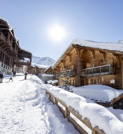 Exterior of snowy VIP SKI Bellevarde chalets in Val d'Isere on sunny day