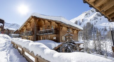 Exterior of snowy VIP SKI Bellevarde chalets in Val d'Isere on sunny day
