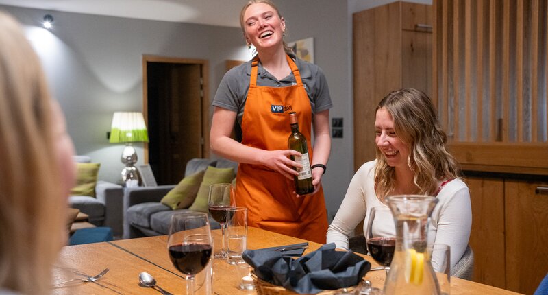 vip ski chalet host pouring wine