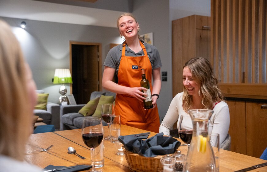 vip ski chalet host pouring wine