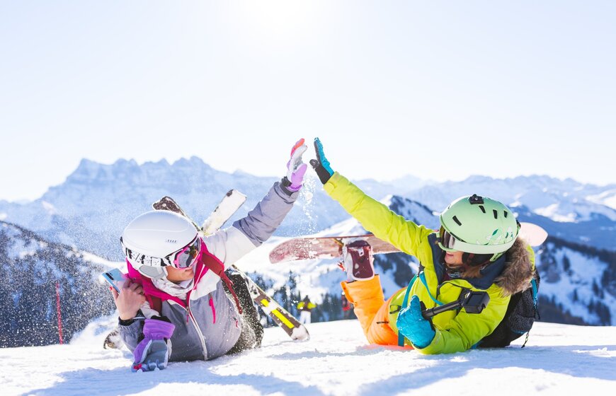 two female friends in the snow with ski equipment