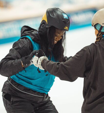 Young woman learning to snowboard 