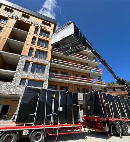 Hot tub being manoeuvred by crane onto balcony of VIP SKI Graciosa chalets in Plagne Centre