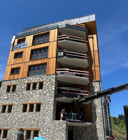 Hot tub being manoeuvred by crane onto balcony of VIP SKI Graciosa chalets in Plagne Centre
