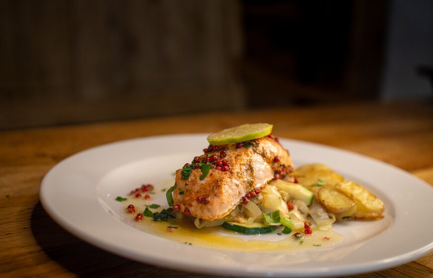 VIP SKI Citrus Salmon dish on a white plae with a slice of lime on top