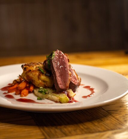 VIP SKI Duck Breast dish on white plate