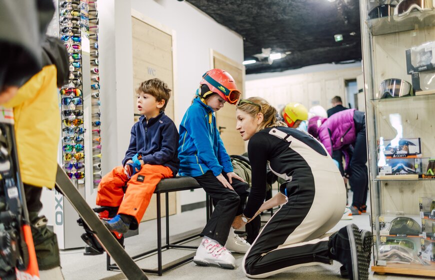 Mother helping children get ready for skiing in VIP SKI Bear Lodge ski room