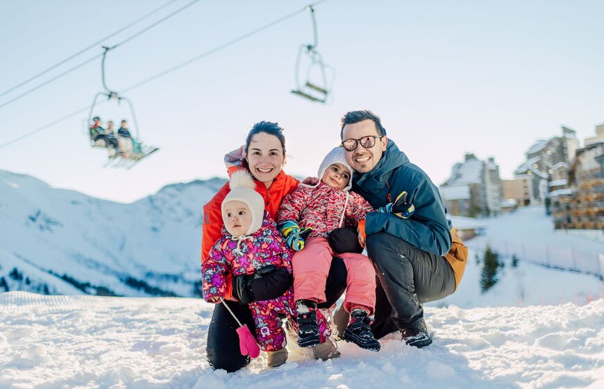 Smiling family of 4 in snowy Avoriaz