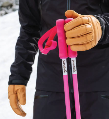 Man holding bright pink Yardsale ski poles
