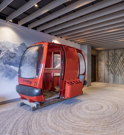 Red cable car in reception area of the Graciosa, La Plagne