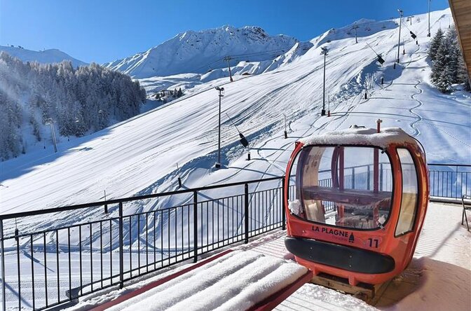 View of slopes from Sagarmatha Penthouse balcony with red La Plagne gondola