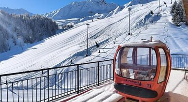 View of slopes from Sagarmatha Penthouse balcony with red La Plagne gondola