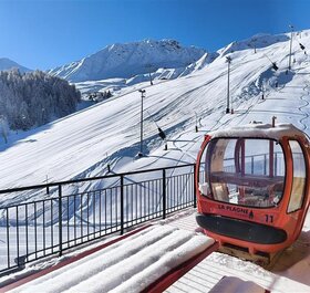 View of slopes from Sagarmatha Penthouse balcony with red La Plagne gondola