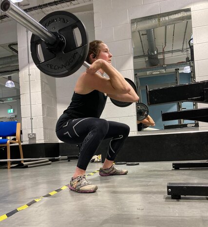 Physio Jo Pollard squatting with bar bell