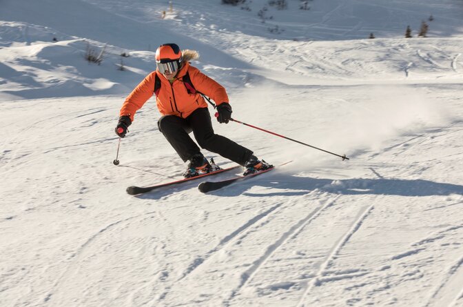 Woman skier carving down ski slope