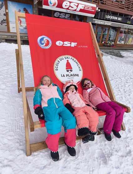 3 children sitting in large ESF La Plagne deckchair