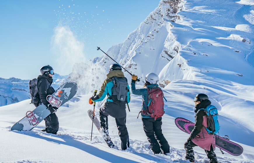 Group of skiers and snowboarders at top of snowy mountain in Avoriaz