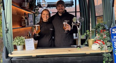 Smiling couple in converted gondola bar