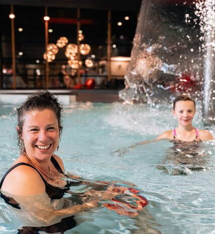 Mother and daughter in swimming pool