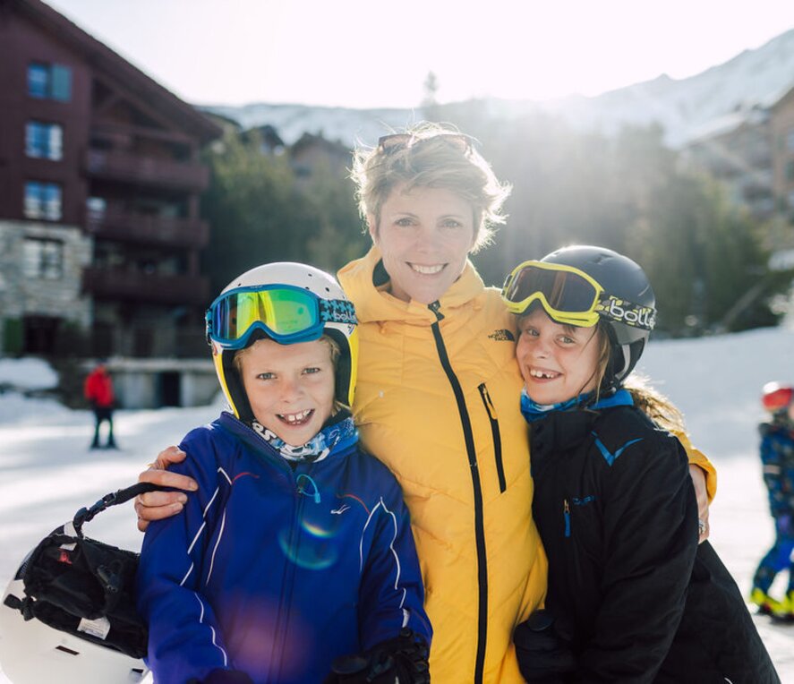 Mum and two children on a ski holiday, outside Bear Lodge, Arc 1950