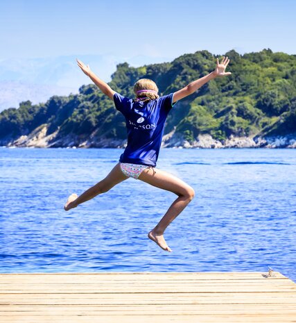 Girl jumping into the sea