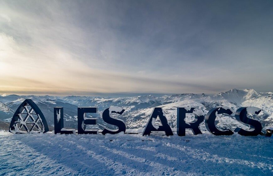 Les Arcs sign, large letters spelling the ski resort with snow covering