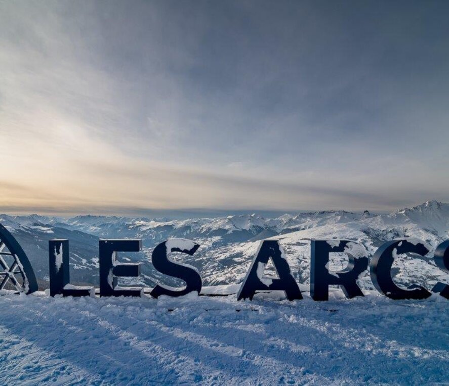 Les Arcs sign, large letters spelling the ski resort with snow covering
