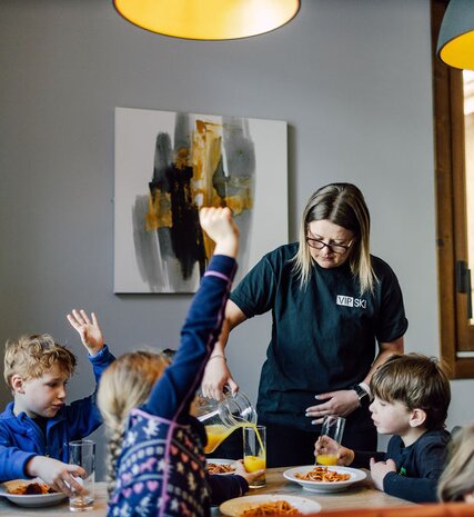 VIP SKI nanny serving lunch to children at Bear Lodge after ski school